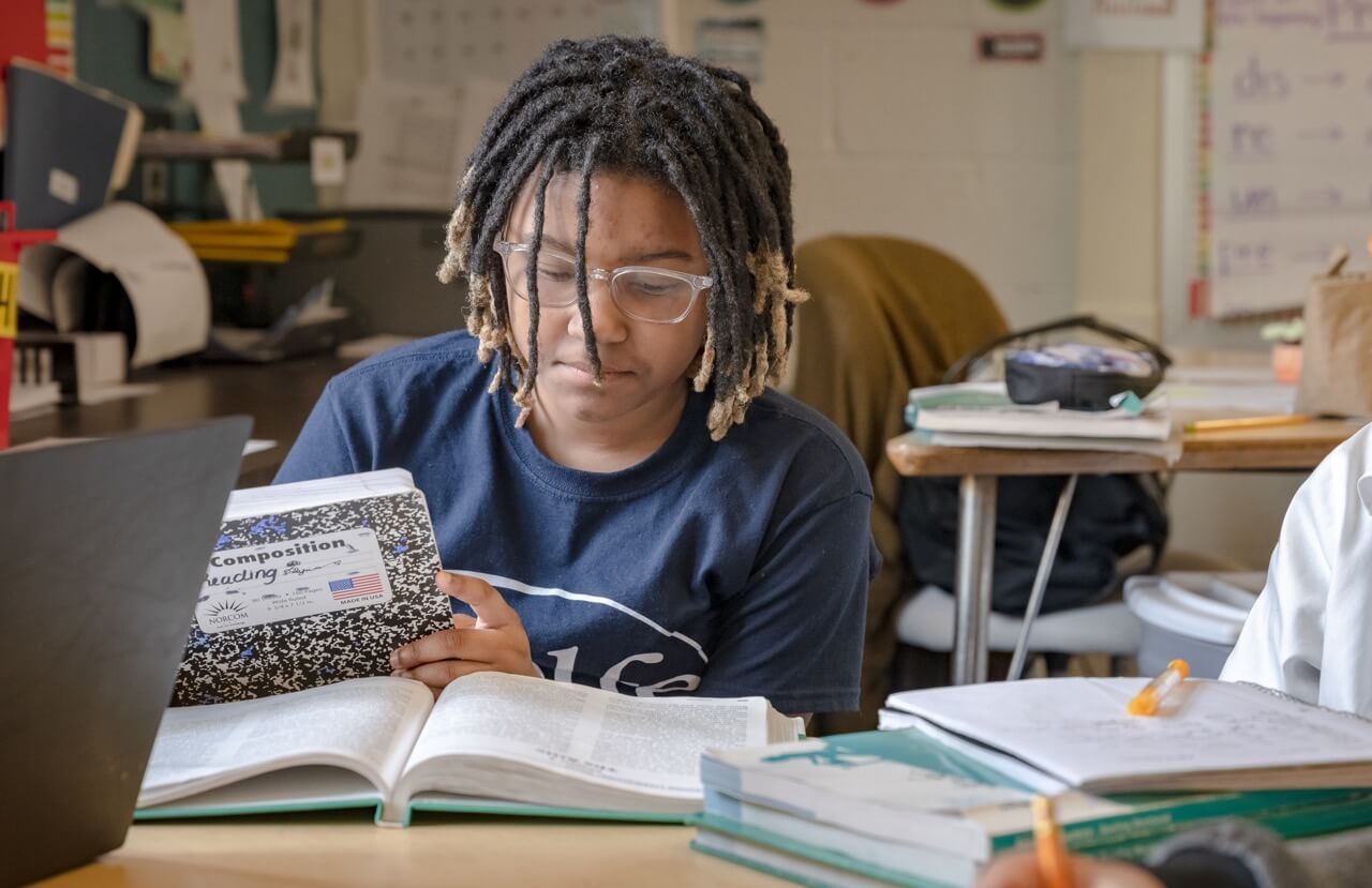 Student with glasses reading