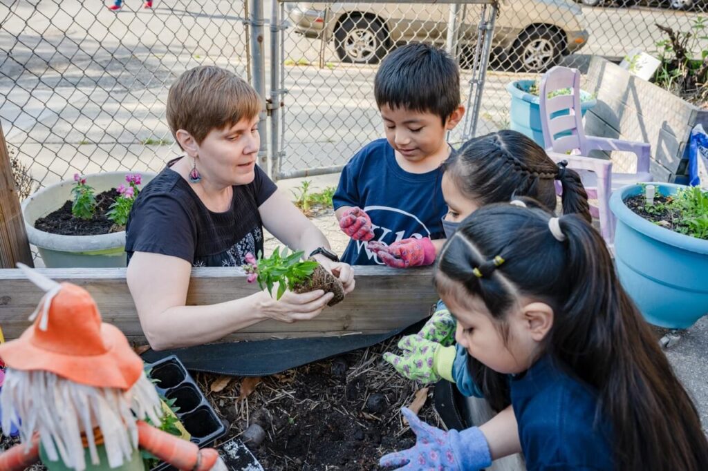 Students planting outside 272 Students planting outside